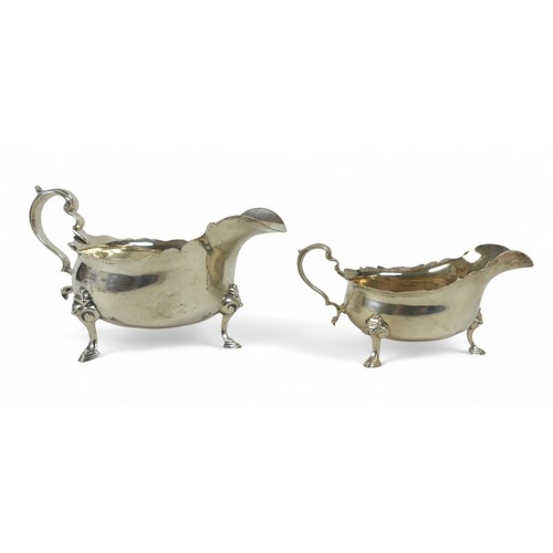 116 - Two silver sauce boats; one London 1937 by Asprey & Co, Birmingham, with shaped rim and three feet, ... 