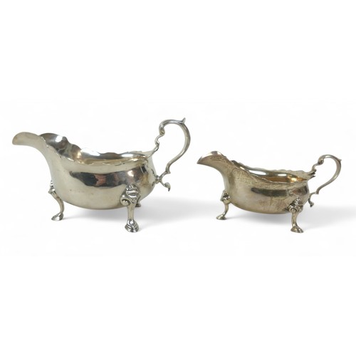 116 - Two silver sauce boats; one London 1937 by Asprey & Co, Birmingham, with shaped rim and three feet, ... 