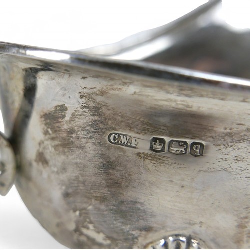 102 - Two silver sauce boats; one Sheffield 1933 with reeded rim, marked maker CWF, with three feet and C ... 