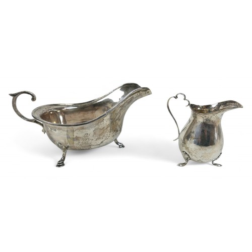 102 - Two silver sauce boats; one Sheffield 1933 with reeded rim, marked maker CWF, with three feet and C ... 