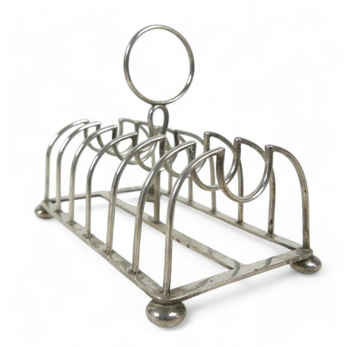 108 - A silver toast rack on four ball feet, Chester 1904, Maker GNRH for George Nathan & Ridley Hayes, 14... 