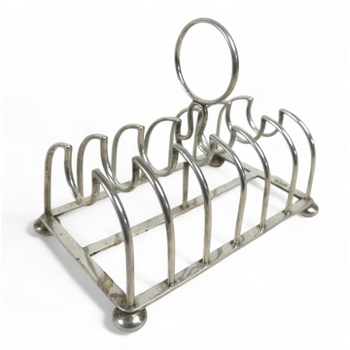 108 - A silver toast rack on four ball feet, Chester 1904, Maker GNRH for George Nathan & Ridley Hayes, 14... 