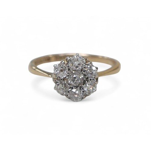 83 - An 18ct gold and platinum seven stone diamond daisy ring, each round cut stone approximately 3mm dia... 