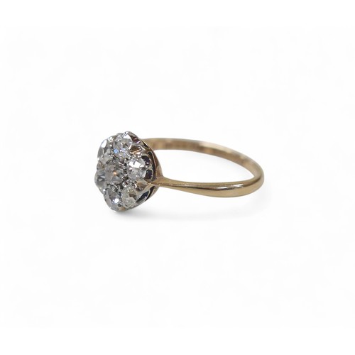 83 - An 18ct gold and platinum seven stone diamond daisy ring, each round cut stone approximately 3mm dia... 