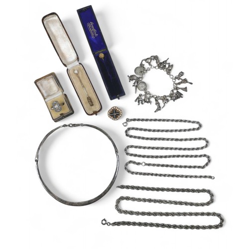 38 - A collection of jewellery, comprising silver chains, ring, pins and a cats eye and pearl yellow meta... 