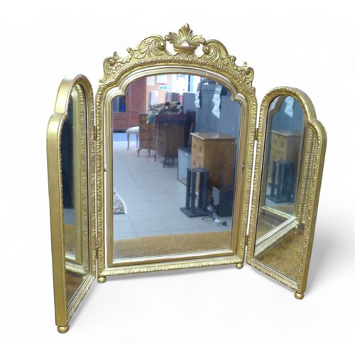 358 - An ornate gilt triple dressing table mirror, 100 by 3 by 80cm high.