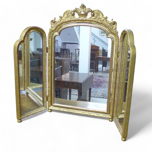 358 - An ornate gilt triple dressing table mirror, 100 by 3 by 80cm high.