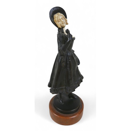 217 - An early 20th century bronze and ivory figure, modelled as a girl in a bonnet with flower basket, st... 