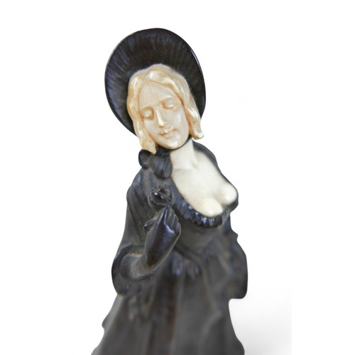 217 - An early 20th century bronze and ivory figure, modelled as a girl in a bonnet with flower basket, st... 