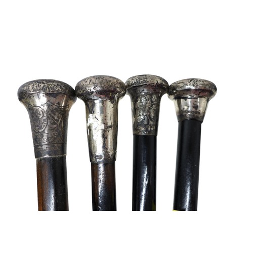 262 - Four silver top walking canes and a blue and white stick stand, (5)