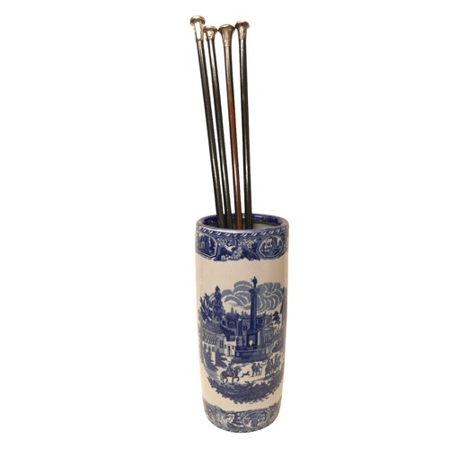 262 - Four silver top walking canes and a blue and white stick stand, (5)