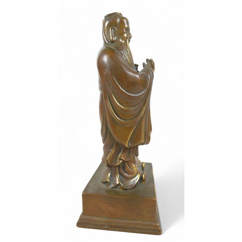 175 - A Chinese bronze figure, 13 by 11 by 29cm high.