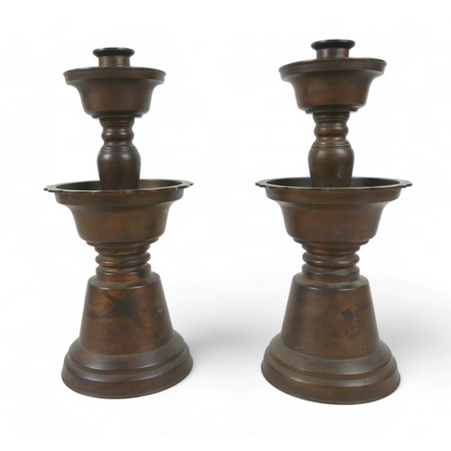 171 - A pair of oriental bell shaped altar candlesticks, made in Hong Kong, 14cm diameter by 33cm high.