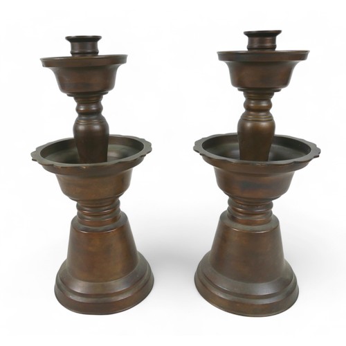 171 - A pair of oriental bell shaped altar candlesticks, made in Hong Kong, 14cm diameter by 33cm high.