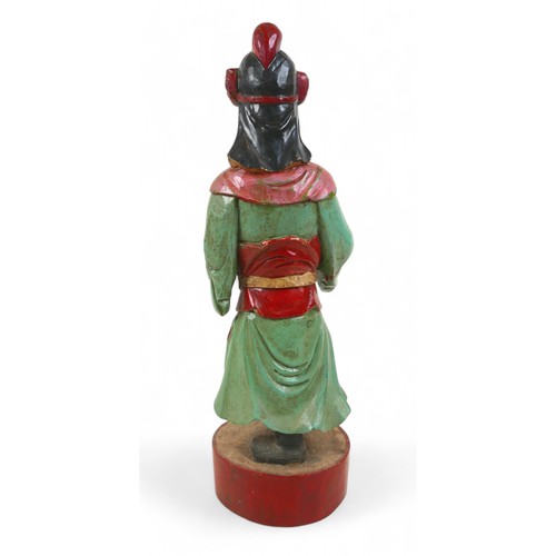 158 - A carved painted wooden figure, 15 by 13 by 47cm high.