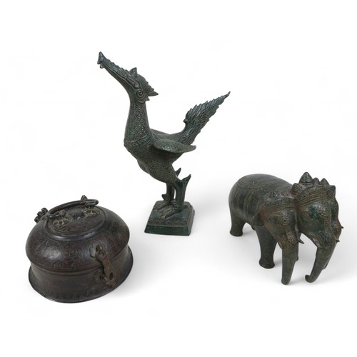 167 - A metal Airavata figure, a phoenix bird and a metal lidded container, the phoenix measures 28 by 13 ... 