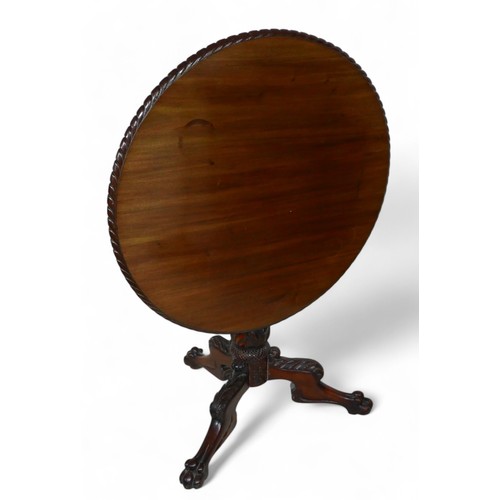 366 - A 19th century carved mahogany tilt top tripod table, 83cm diameter, 72cm high.