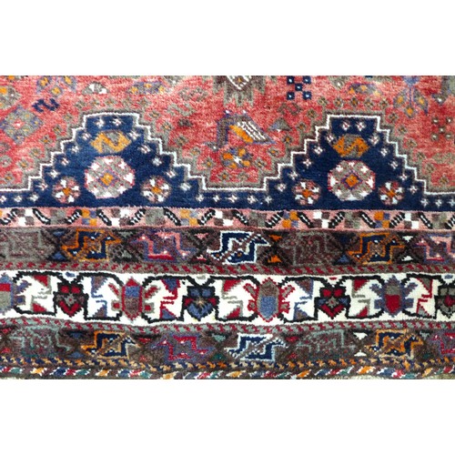 371 - A Shiraz rug, with red ground and three central lozenges surrounded by other geometric designs, 283 ... 