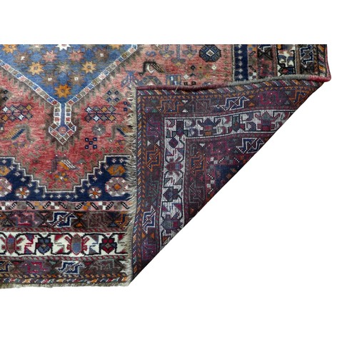 371 - A Shiraz rug, with red ground and three central lozenges surrounded by other geometric designs, 283 ... 