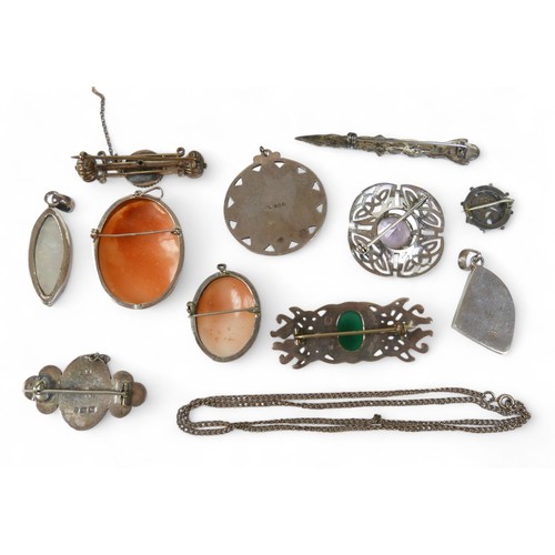 36 - A group of silver jewellery, including brooches, pendants and a chain. (1 bag)