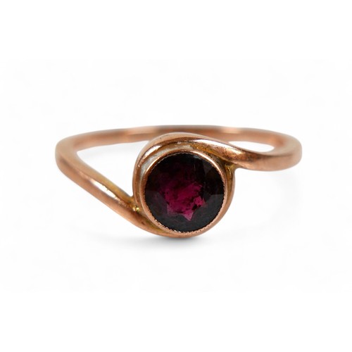 79 - A 9ct rose gold and garnet ring, the round cut garnet measure approximately 5.5mm diameter, in a rub... 