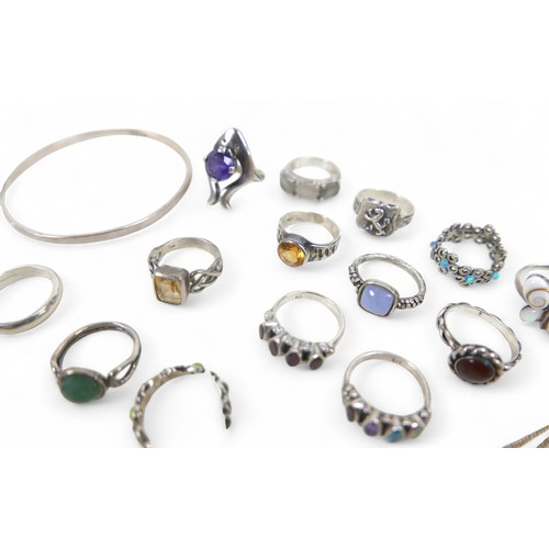 56 - A collection of silver jewellery, comprising rings, necklaces, pendants and a bangle. (28)