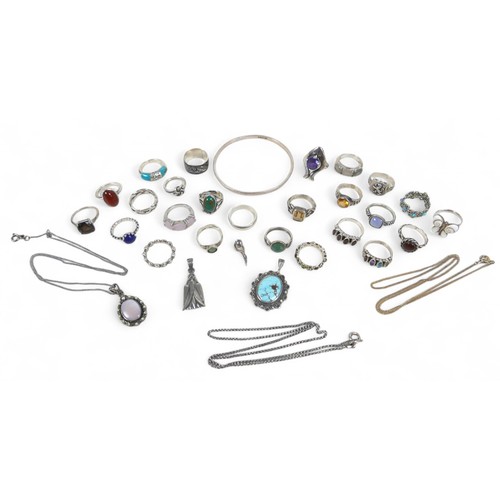 56 - A collection of silver jewellery, comprising rings, necklaces, pendants and a bangle. (28)