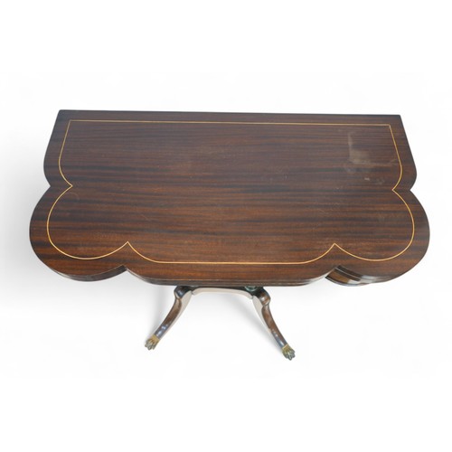 355 - A regency style mahogany card table, with a shaped folder top on a pillared platform base and out-sw... 