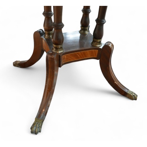 355 - A regency style mahogany card table, with a shaped folder top on a pillared platform base and out-sw... 