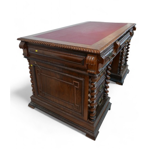 372 - A free standing Portuguese hardwood twin pedestal desk, with nine drawers and sugar barrel twist sup... 