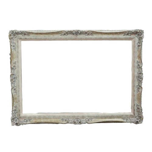 316 - A modern mirror in a swept frame, 107 by 5 by 77cm.