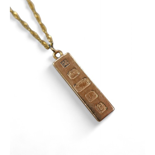 86 - A 9ct gold ingot with a yellow metal chain necklace, the ingot 9.8g, the clasp stamped 9ct but there... 