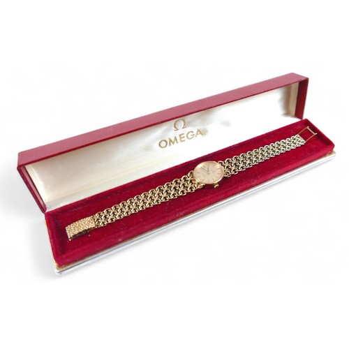 110 - A 9ct gold Omega Geneve lady's wristwatch, with 9ct gold fancy link bracelet strap, 20mm case, with ... 