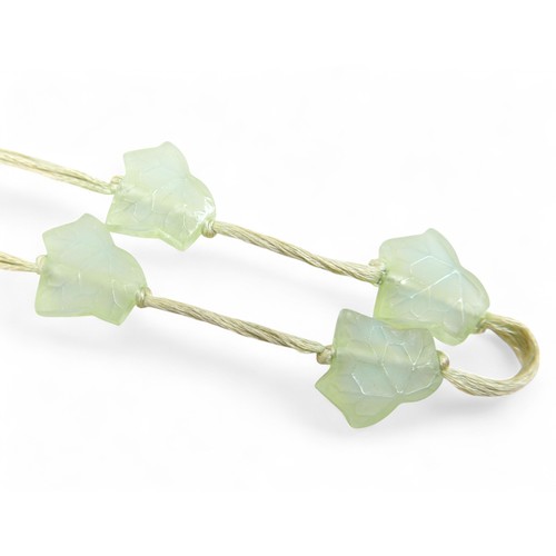 77 - A Lalique 'Feuilles de Lierre' necklace, with twenty glass beads on silk thread, necklace 58cm long.