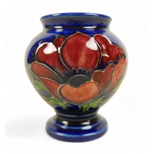 155 - A group of five pieces of Moorcroft pottery, comprising an Apollo Butterfly mug, 9.5cm high, a Hibis... 