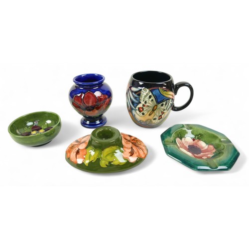 155 - A group of five pieces of Moorcroft pottery, comprising an Apollo Butterfly mug, 9.5cm high, a Hibis... 