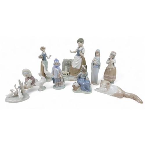 157 - A large collection of Lladro/Nao figurines, including Girl Feeding Goose, 24cm high, Boy with Dog, 5... 