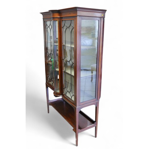 369 - An Edwardian inlaid mahogany display cabinet, with a central bow glass panel flanked either side wit... 