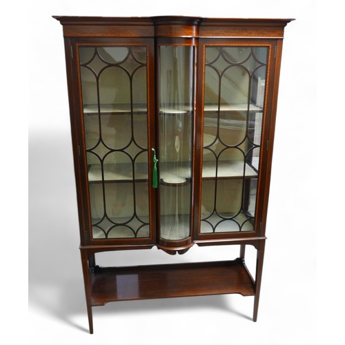 369 - An Edwardian inlaid mahogany display cabinet, with a central bow glass panel flanked either side wit... 