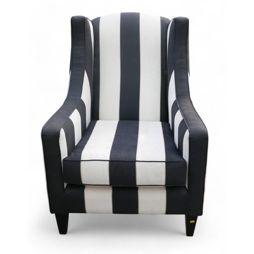 349 - A modern wing back armchair, upholstered in black and white striped material, 74 by 86 by 99cm high.