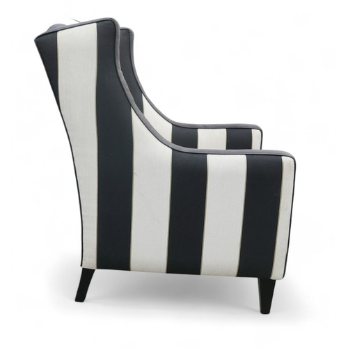 349 - A modern wing back armchair, upholstered in black and white striped material, 74 by 86 by 99cm high.