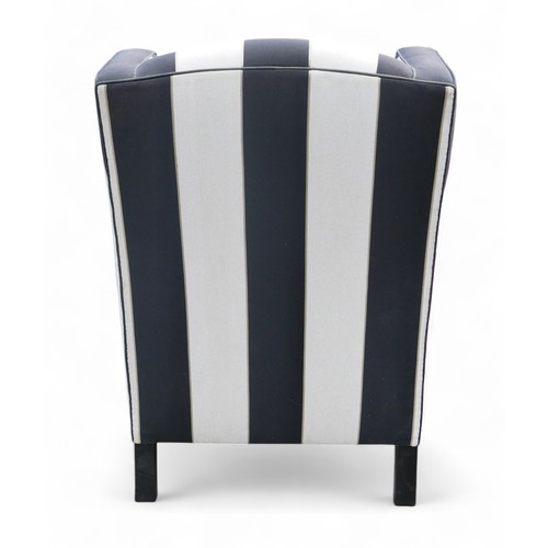 349 - A modern wing back armchair, upholstered in black and white striped material, 74 by 86 by 99cm high.