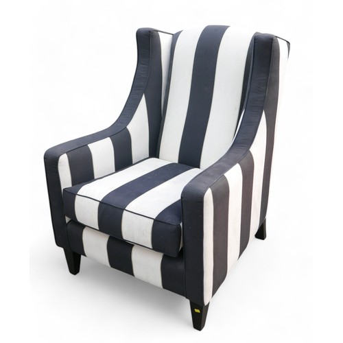 349 - A modern wing back armchair, upholstered in black and white striped material, 74 by 86 by 99cm high.