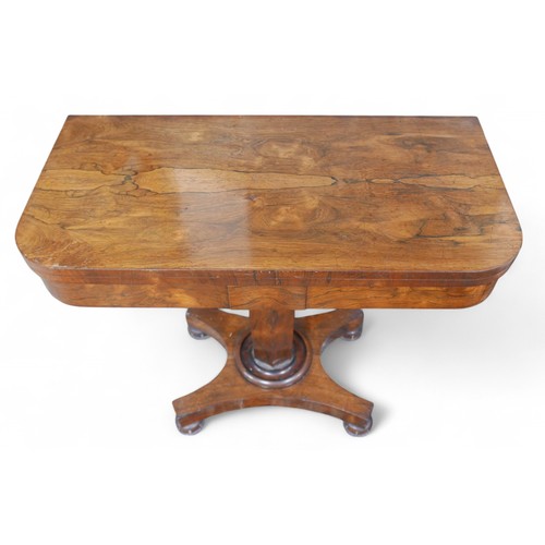 359 - A 19th century rosewood folder top card table, on a tapering octagonal column and platform base with... 