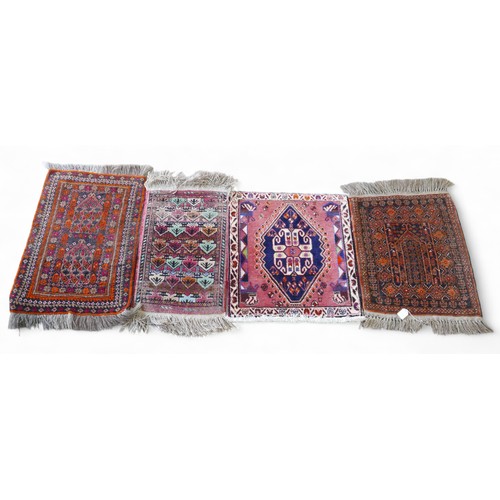 336 - A collection of four small hand knotted rugs, largest 52 by 80cm. (4)