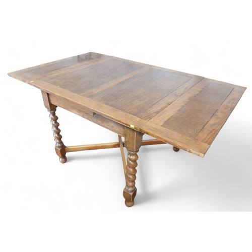 343 - A 1930's oak barley twist drawer leaf dining table, 90 by 91 by 75cm, will extend to 150cm.