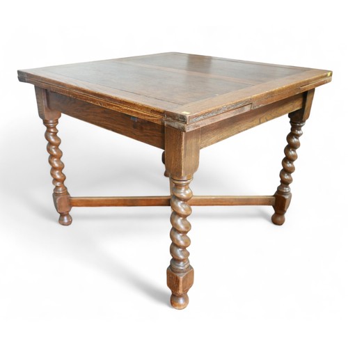 343 - A 1930's oak barley twist drawer leaf dining table, 90 by 91 by 75cm, will extend to 150cm.