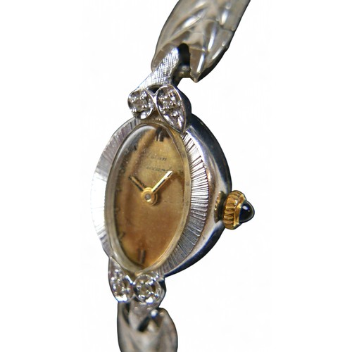 139 - A Lucien Piccard diamond and 14k gold ladies wrist watch, oval dial, with 10k strap.