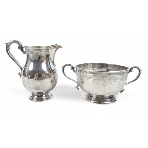 2 - An Elizabeth II Irish silver five piece tea and coffee service, of ovoid form with engraved foliate ... 