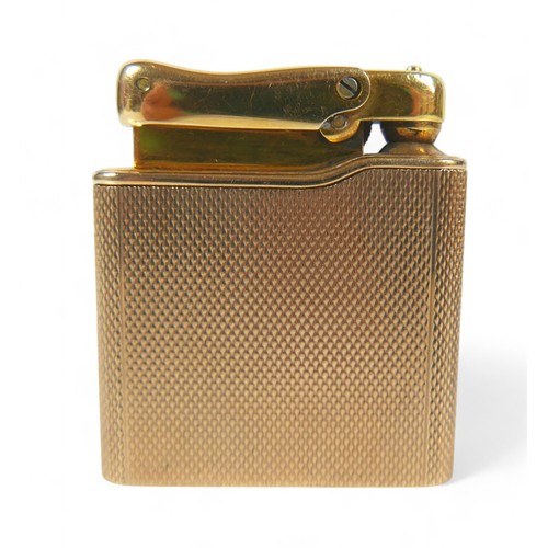 87 - A 9ct gold cased Colibri Monogas lighter, with engine turned decoration, 72.4g gross weight, 9ct gol... 